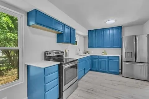 a kitchen with stainless steel appliances granite countertop a refrigerator sink and cabinets