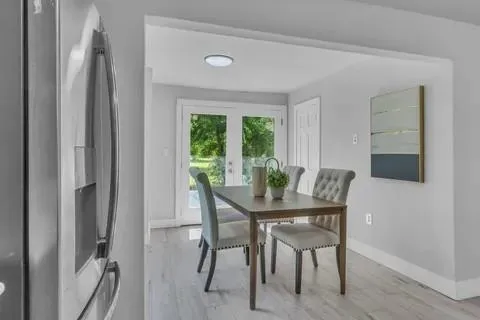 a view of a dining room with furniture and a window