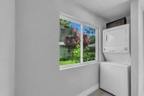 a room with a window and a white door