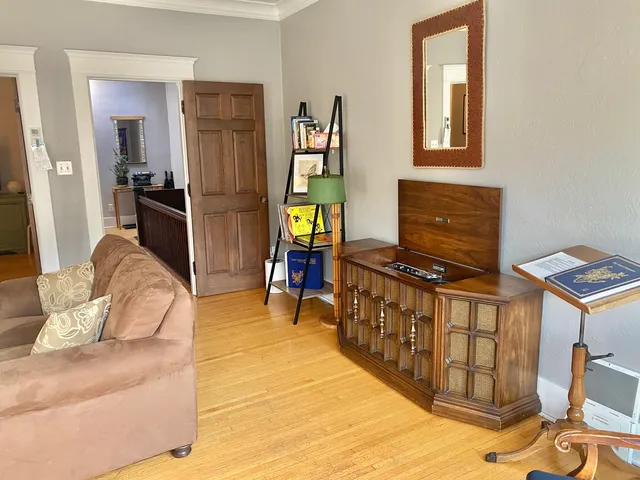 a living room with furniture and a lamp
