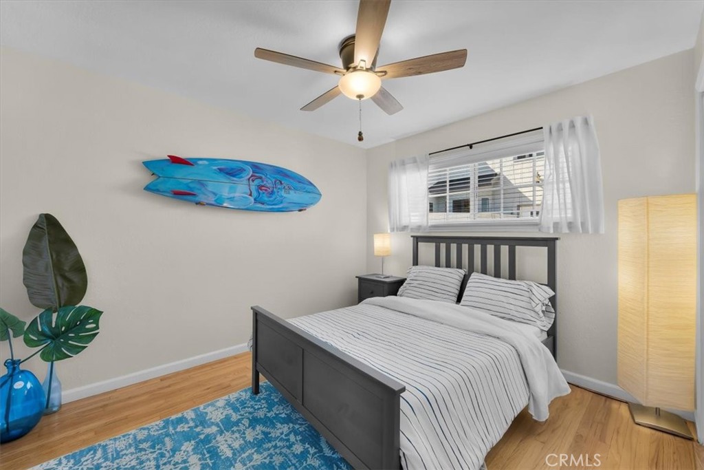 2407 Ripley Avenue Redondo Beach, CA 90278 - Photo 16 of 39 a bedroom with a bed chandelier and a window