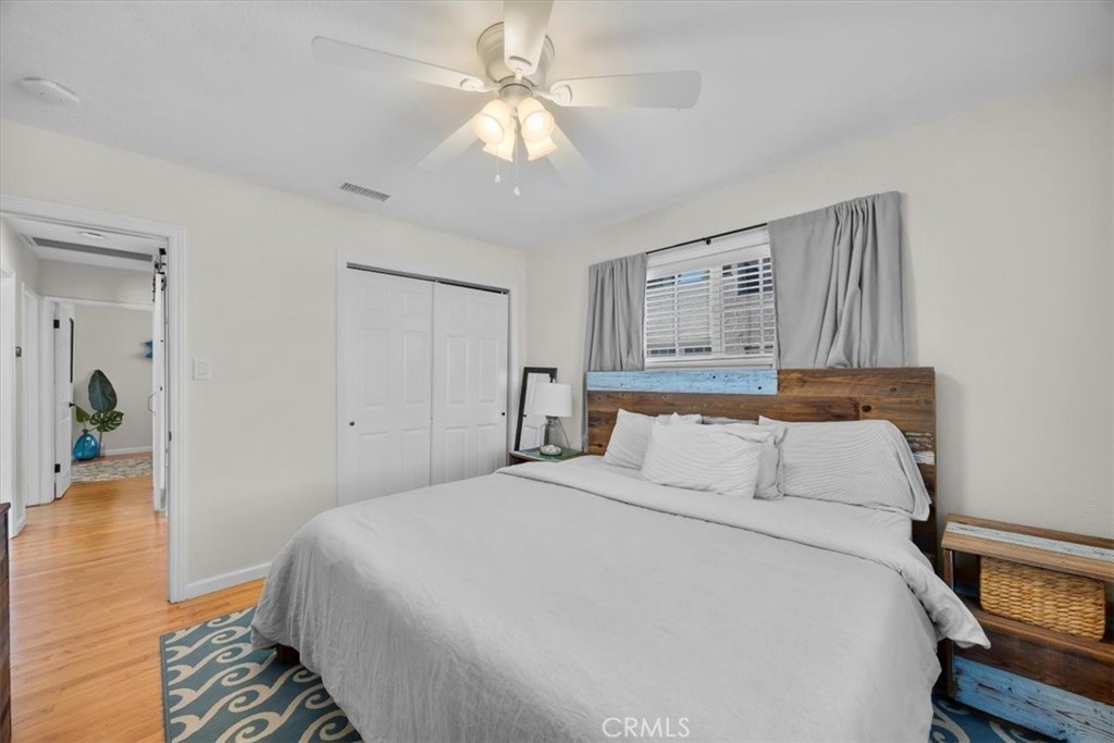 2407 Ripley Avenue Redondo Beach, CA 90278 - Photo 19 of 39 a bedroom with a large bed and a chandelier