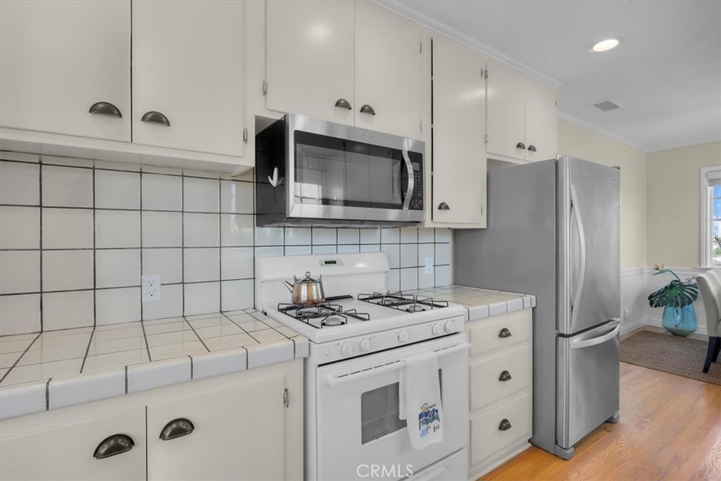 2407 Ripley Avenue Redondo Beach, CA 90278 - Photo 9 of 39 a kitchen with granite countertop a stove a sink and a refrigerator