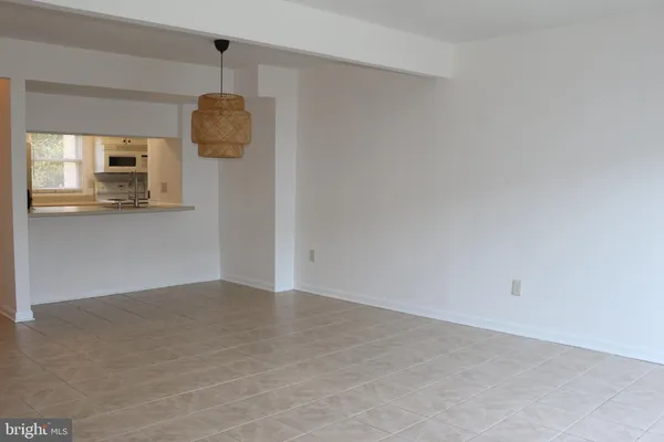 a view of empty room with wooden floor and window