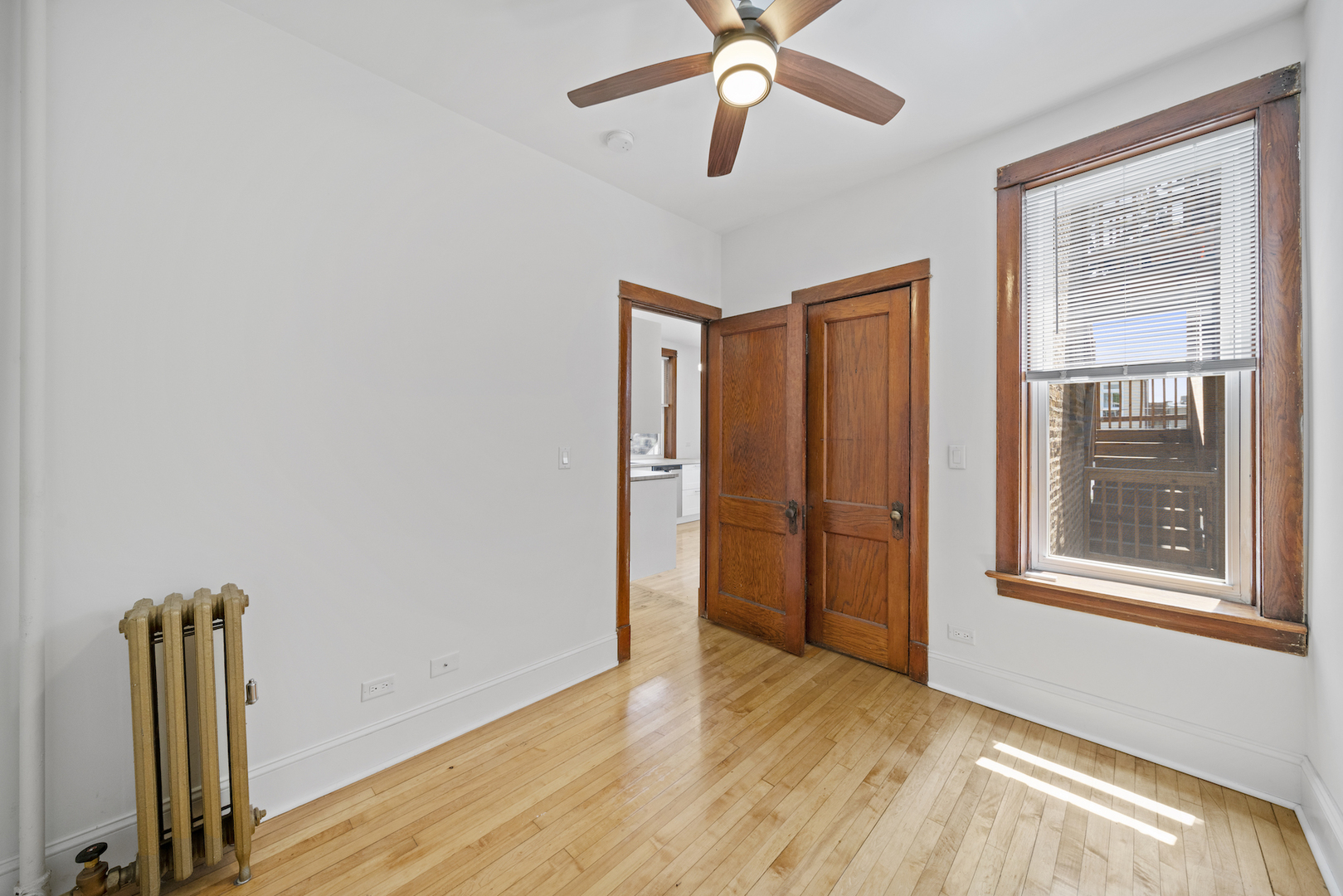 2545 West Walton Street, Unit 2 Chicago, IL 60622 - Photo 13 of 20 a view of empty room with wooden floor and fan