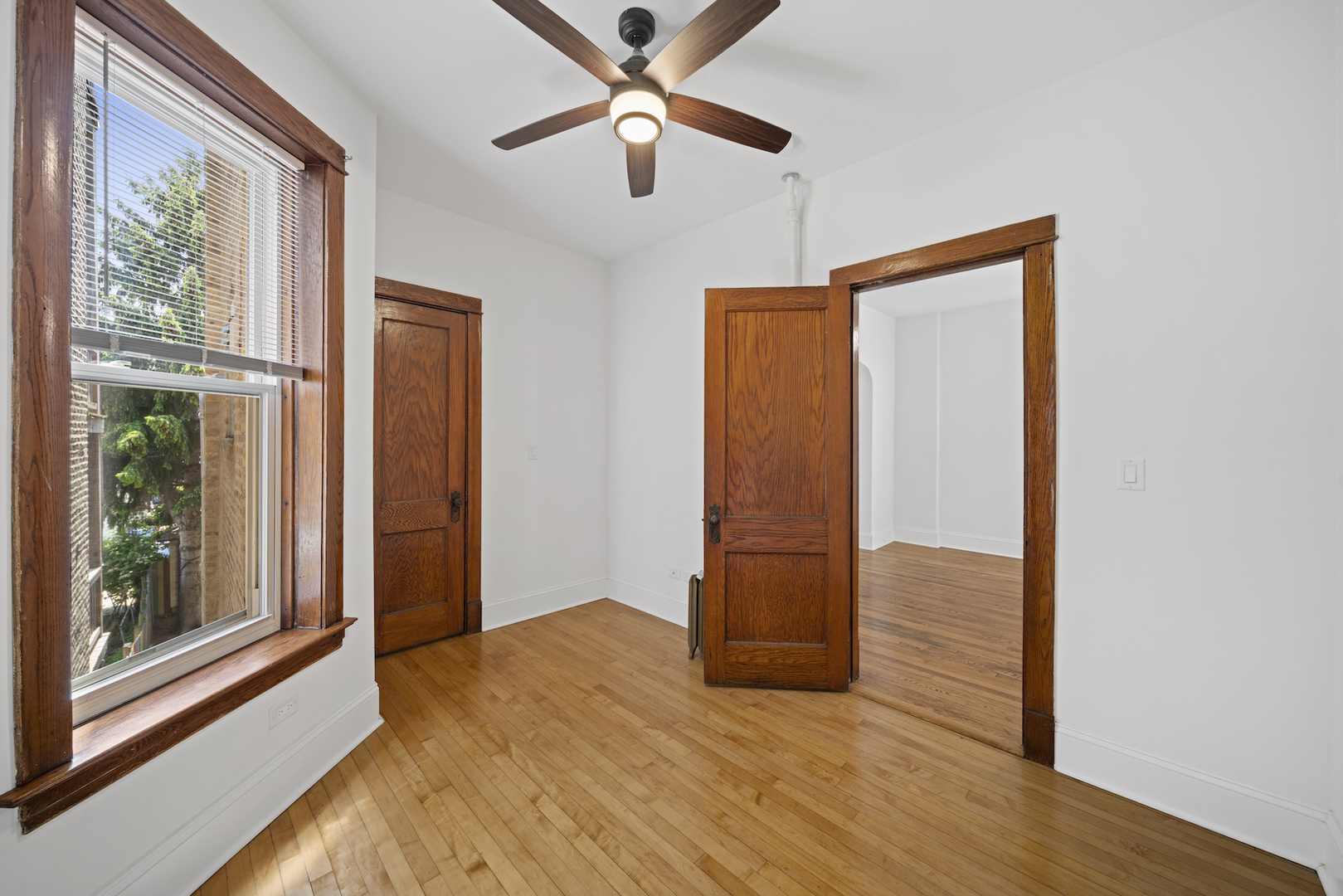 2545 West Walton Street, Unit 2 Chicago, IL 60622 - Photo 16 of 20 a view of empty room with wooden floor and fan