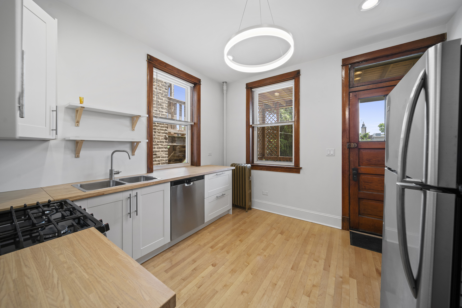 2545 West Walton Street, Unit 2 Chicago, IL 60622 - Photo 7 of 20 a kitchen with stainless steel appliances a refrigerator and a sink