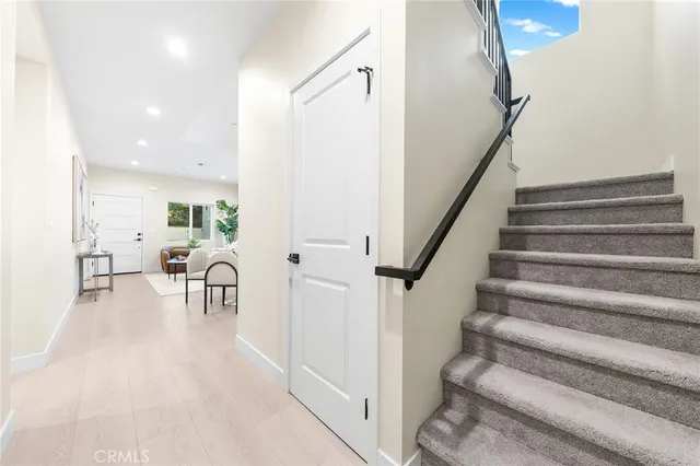 a view of a dining room with furniture and a potted plant