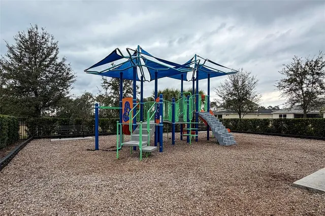 a view of wooden deck with a table and chairs under an umbrella
