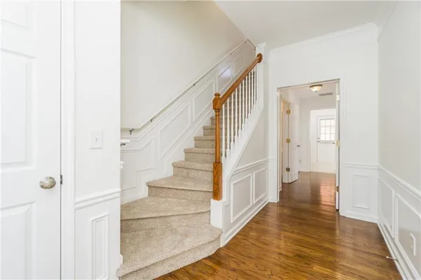 a view of a hallway with wooden floor and entryway