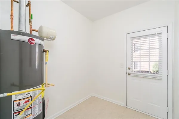 an empty room with windows and fireplace