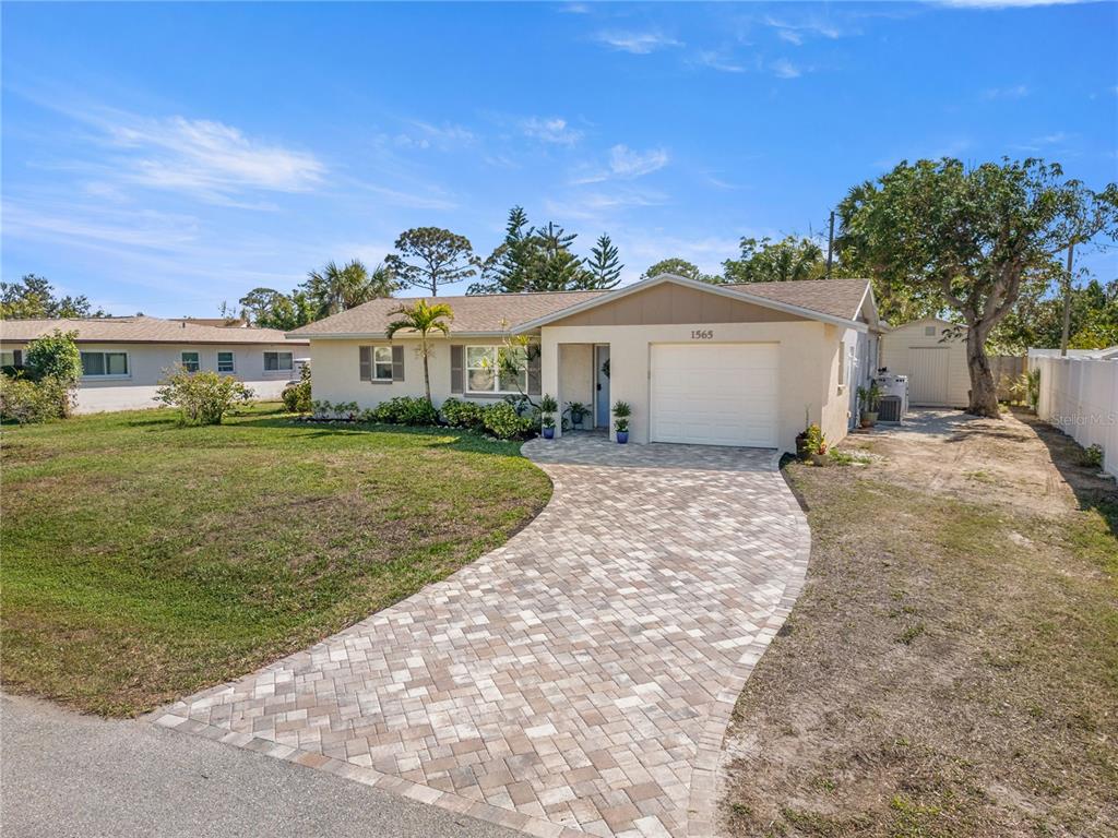 1565 Saturn Road Venice, FL 34293 - Photo 1 of 1 a view of a house with a yard and potted plants