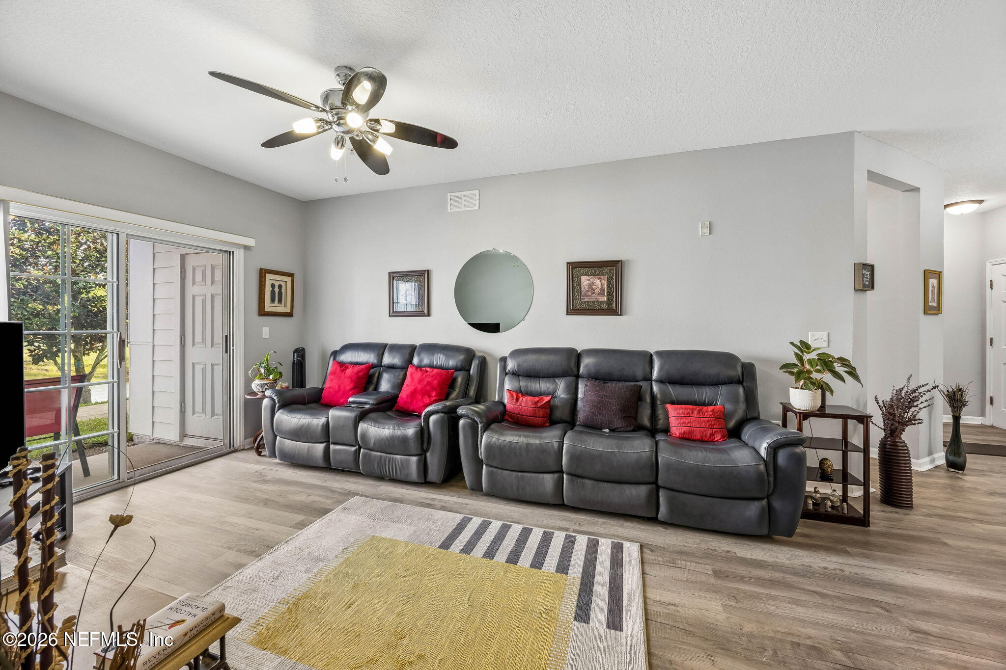 8215 Green Parrot Road, Unit 106 Jacksonville, FL 32256 - Photo 13 of 76 a living room with furniture and wooden floor