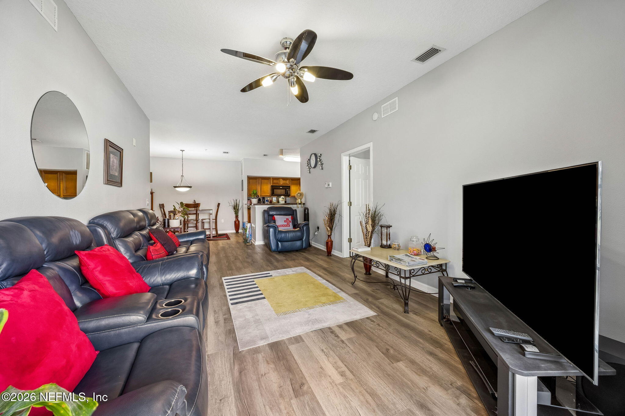 8215 Green Parrot Road, Unit 106 Jacksonville, FL 32256 - Photo 14 of 76 a living room with furniture and a flat screen tv