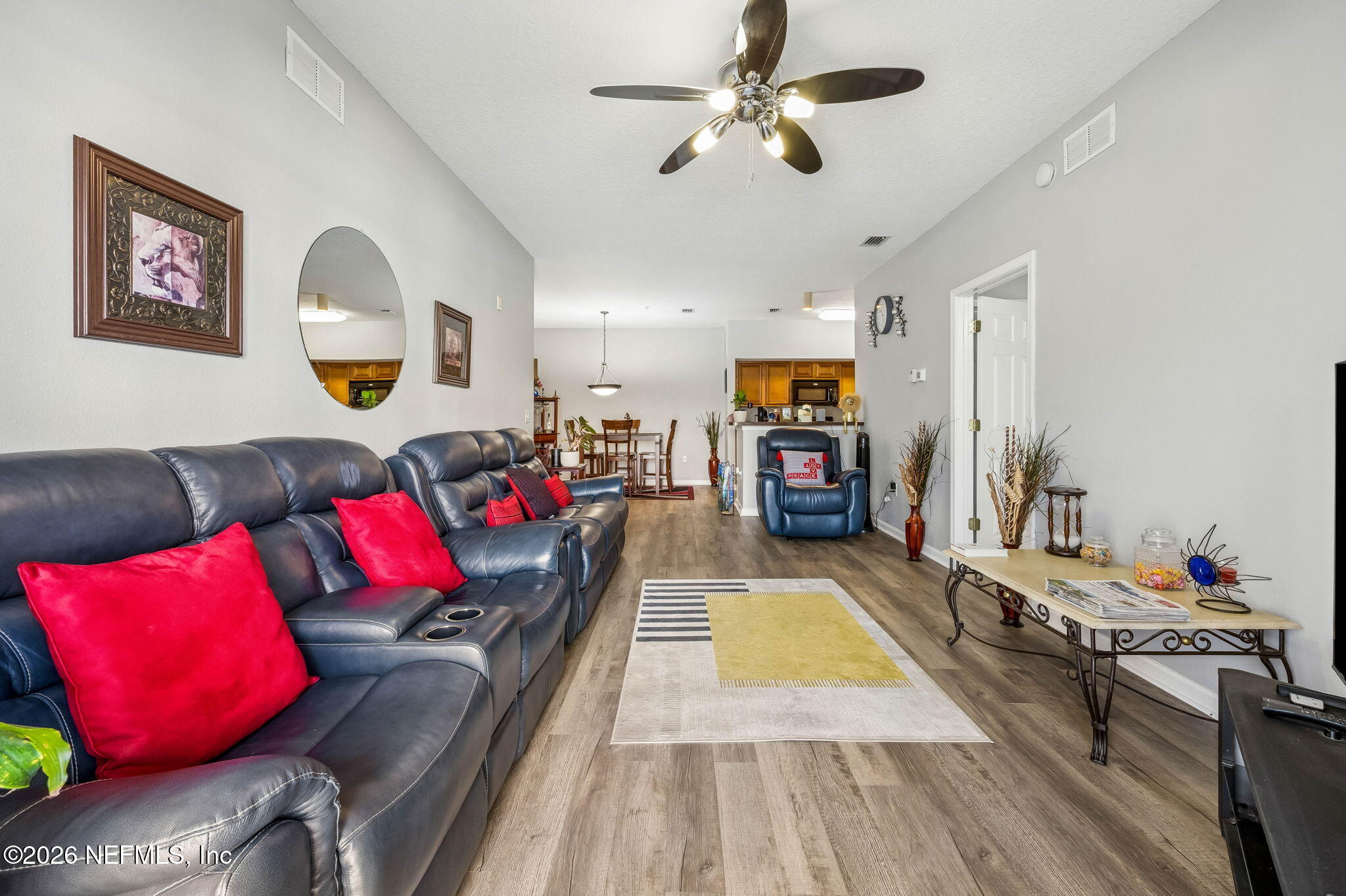 8215 Green Parrot Road, Unit 106 Jacksonville, FL 32256 - Photo 15 of 76 a living room with furniture and a flat screen tv