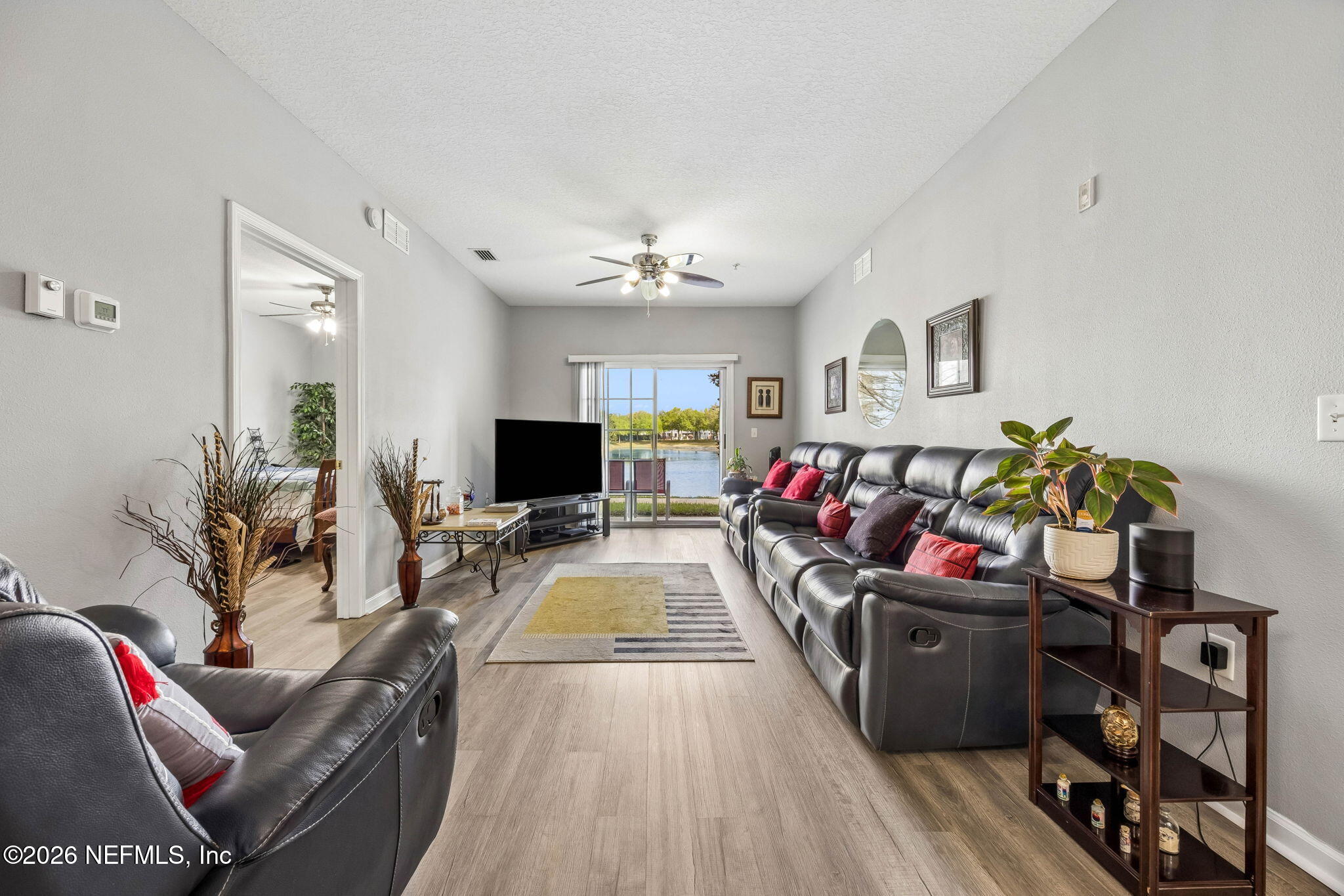8215 Green Parrot Road, Unit 106 Jacksonville, FL 32256 - Photo 16 of 76 a view of a livingroom with furniture and a flat screen tv