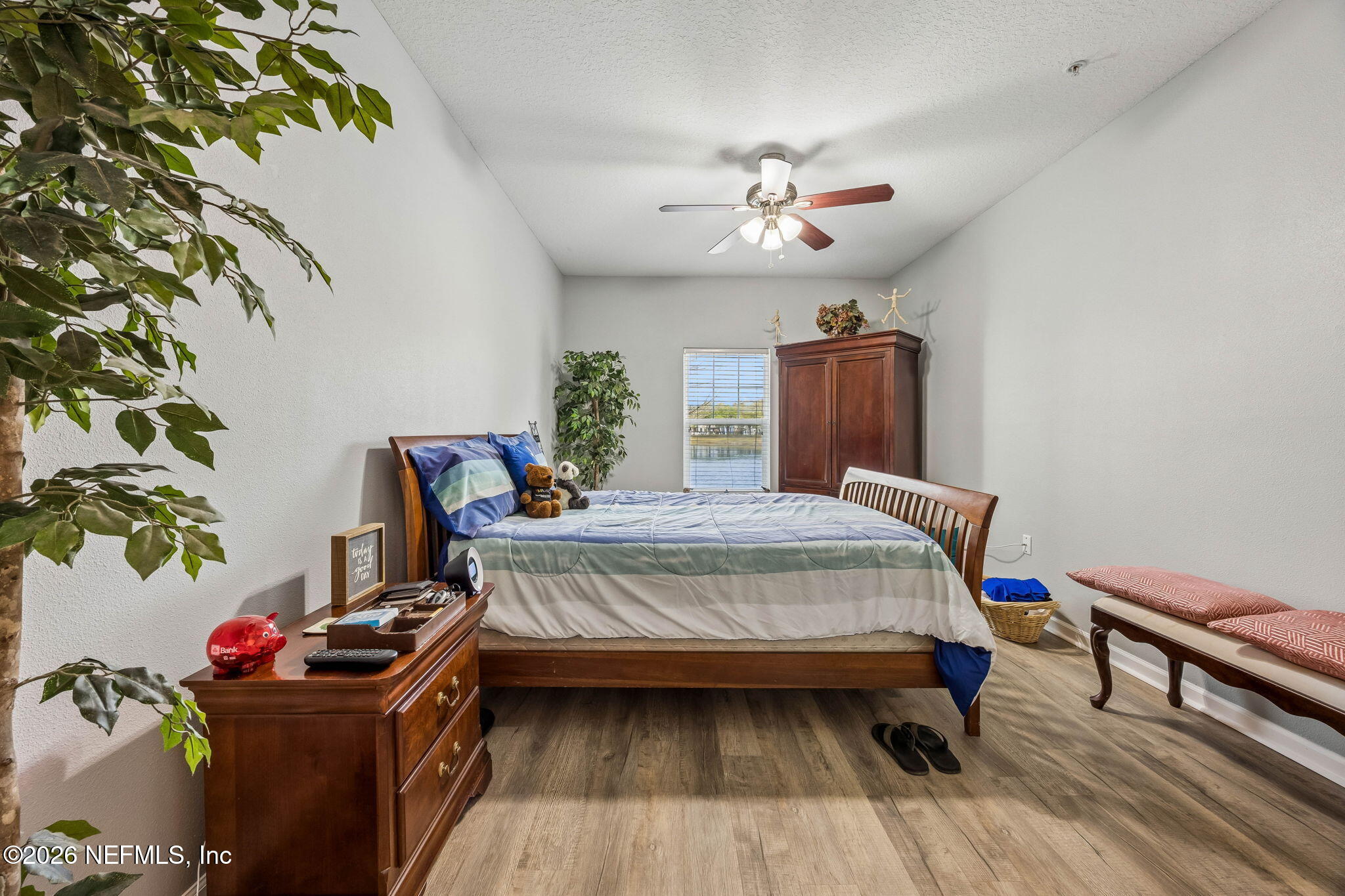 8215 Green Parrot Road, Unit 106 Jacksonville, FL 32256 - Photo 19 of 76 a bedroom with a bed and wooden floor