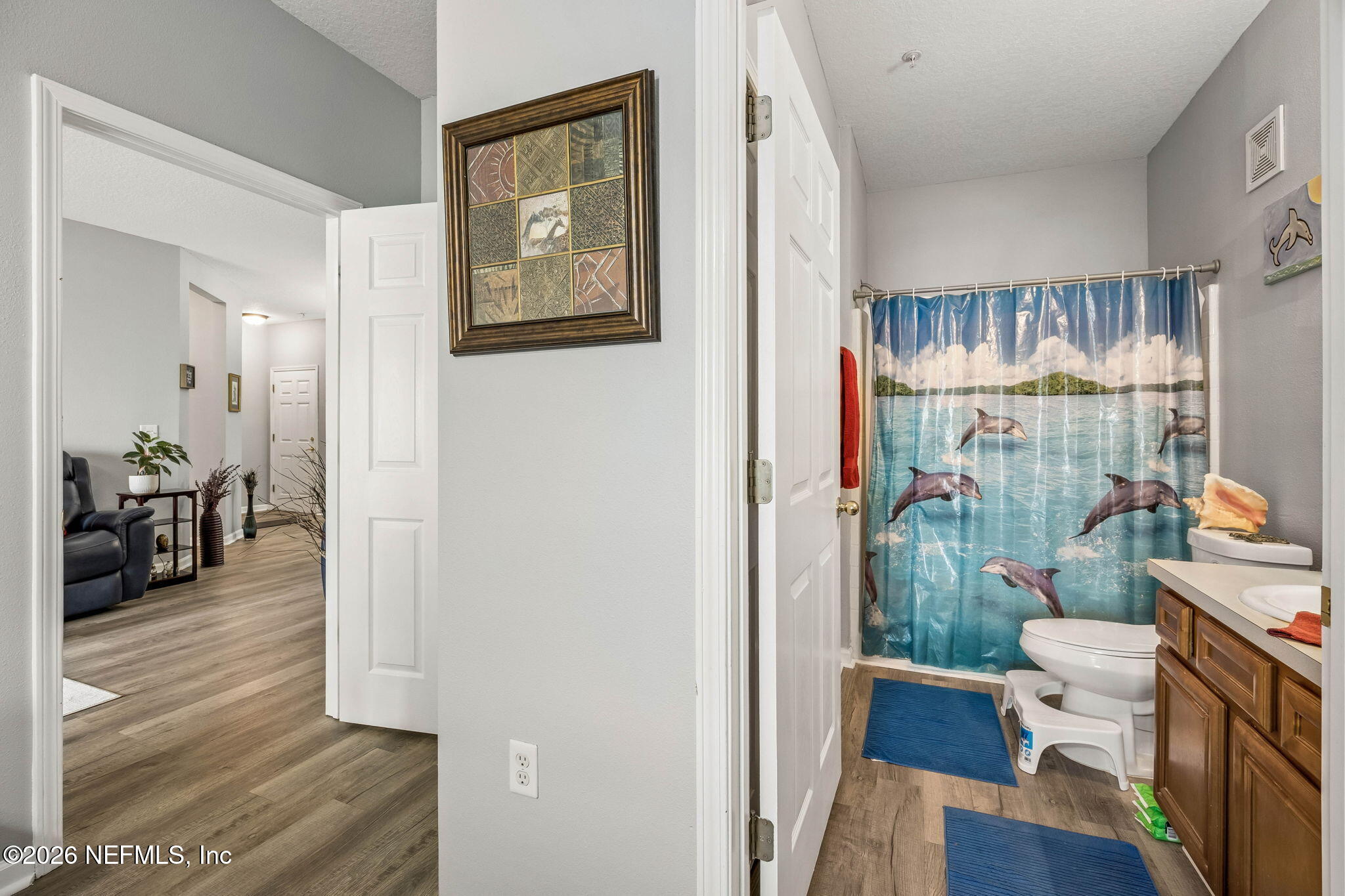 8215 Green Parrot Road, Unit 106 Jacksonville, FL 32256 - Photo 22 of 76 a very nice looking room with a large window and wooden floor