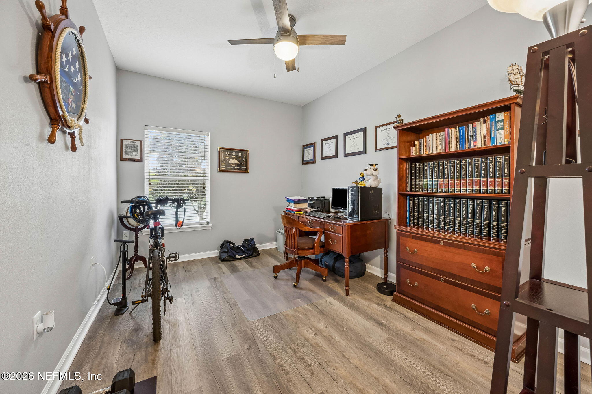 8215 Green Parrot Road, Unit 106 Jacksonville, FL 32256 - Photo 23 of 76 a view of a workspace with furniture window and wooden floor