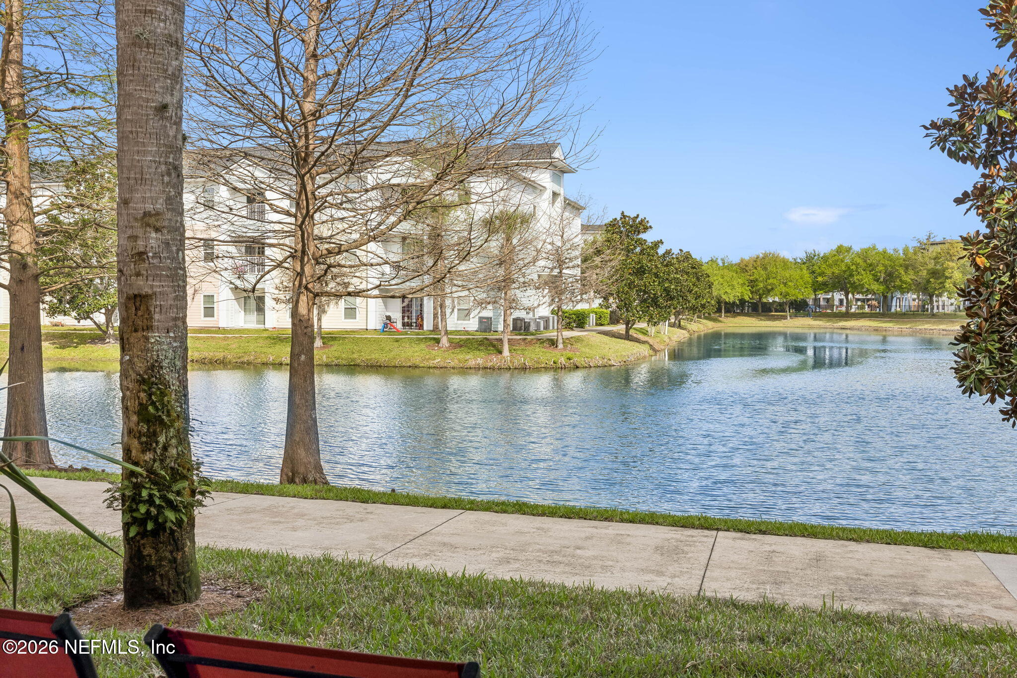 8215 Green Parrot Road, Unit 106 Jacksonville, FL 32256 - Photo 29 of 76 a view of a lake with houses in the background