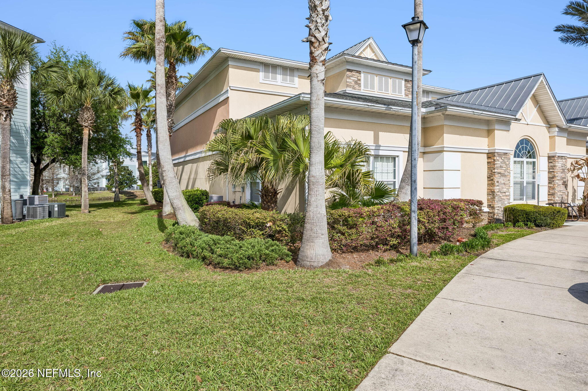 8215 Green Parrot Road, Unit 106 Jacksonville, FL 32256 - Photo 35 of 76 a front view of a house with garden