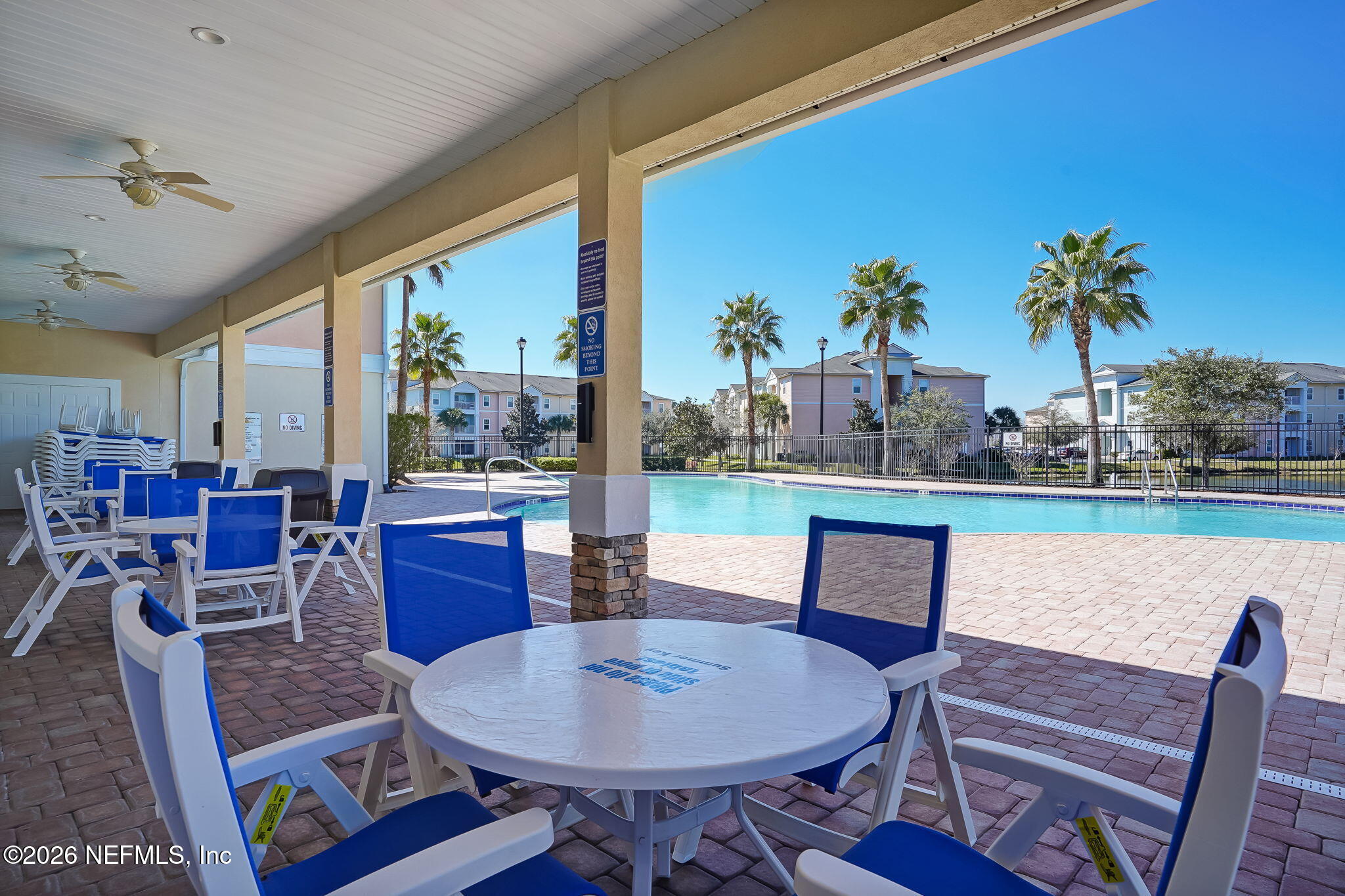 8215 Green Parrot Road, Unit 106 Jacksonville, FL 32256 - Photo 42 of 76 a dining room with furniture a rug and wooden floor