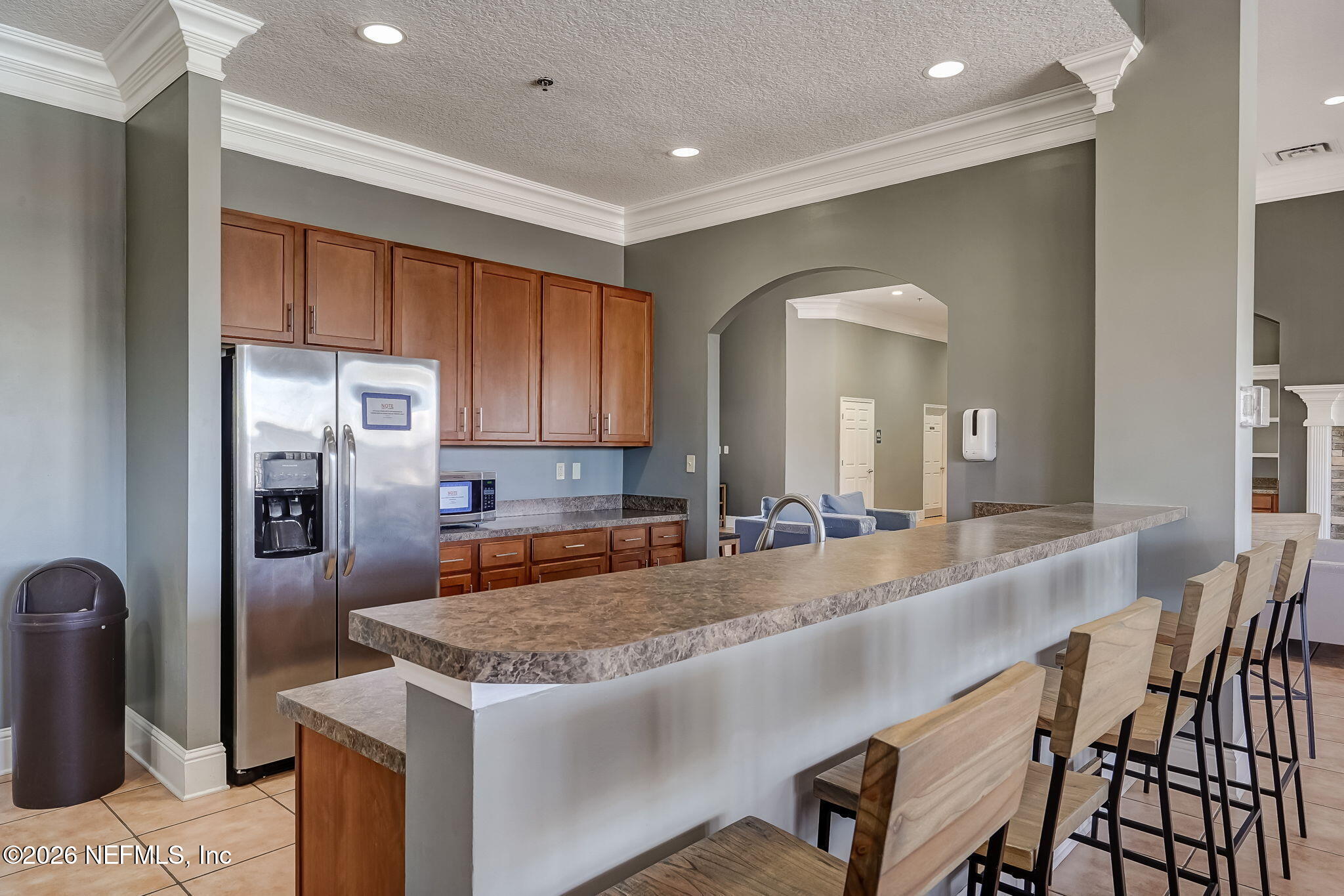 8215 Green Parrot Road, Unit 106 Jacksonville, FL 32256 - Photo 47 of 76 a large kitchen with kitchen island a large counter top space a sink stainless steel appliances and cabinets