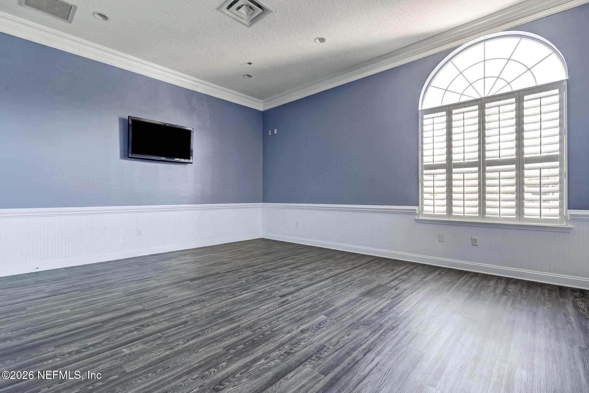 8215 Green Parrot Road, Unit 106 Jacksonville, FL 32256 - Photo 48 of 76 an empty room with wooden floor and windows