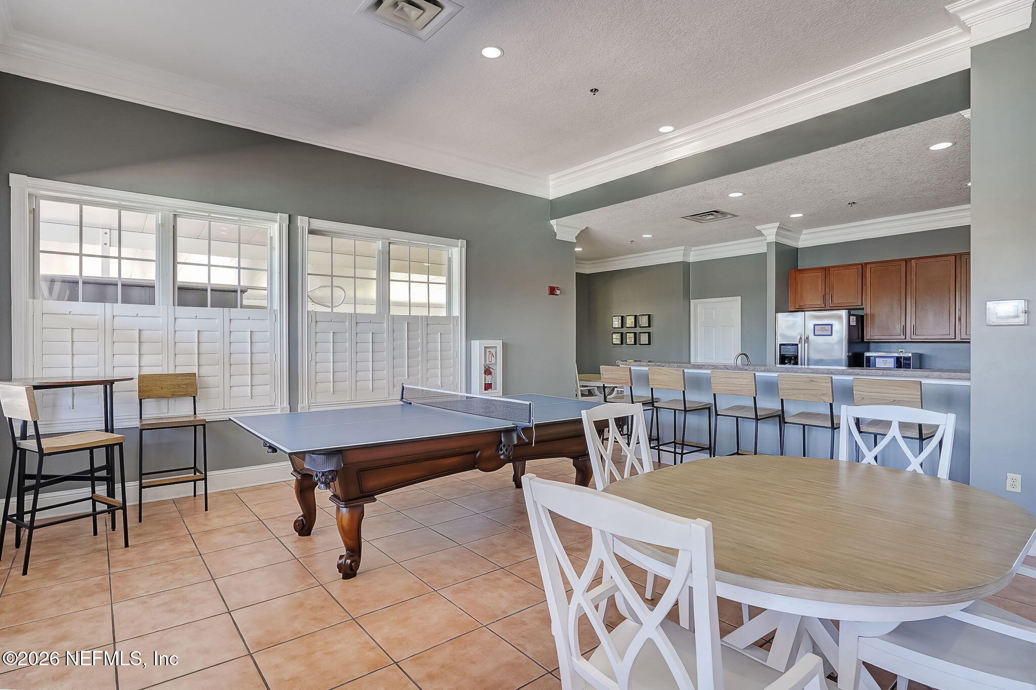 8215 Green Parrot Road, Unit 106 Jacksonville, FL 32256 - Photo 51 of 76 a dining room with a table and chairs