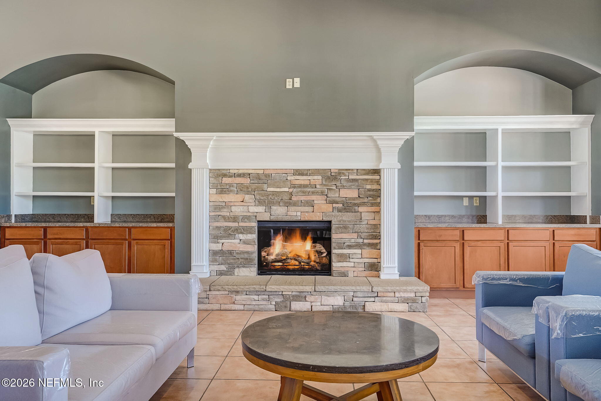 8215 Green Parrot Road, Unit 106 Jacksonville, FL 32256 - Photo 52 of 76 a living room with furniture and a fireplace