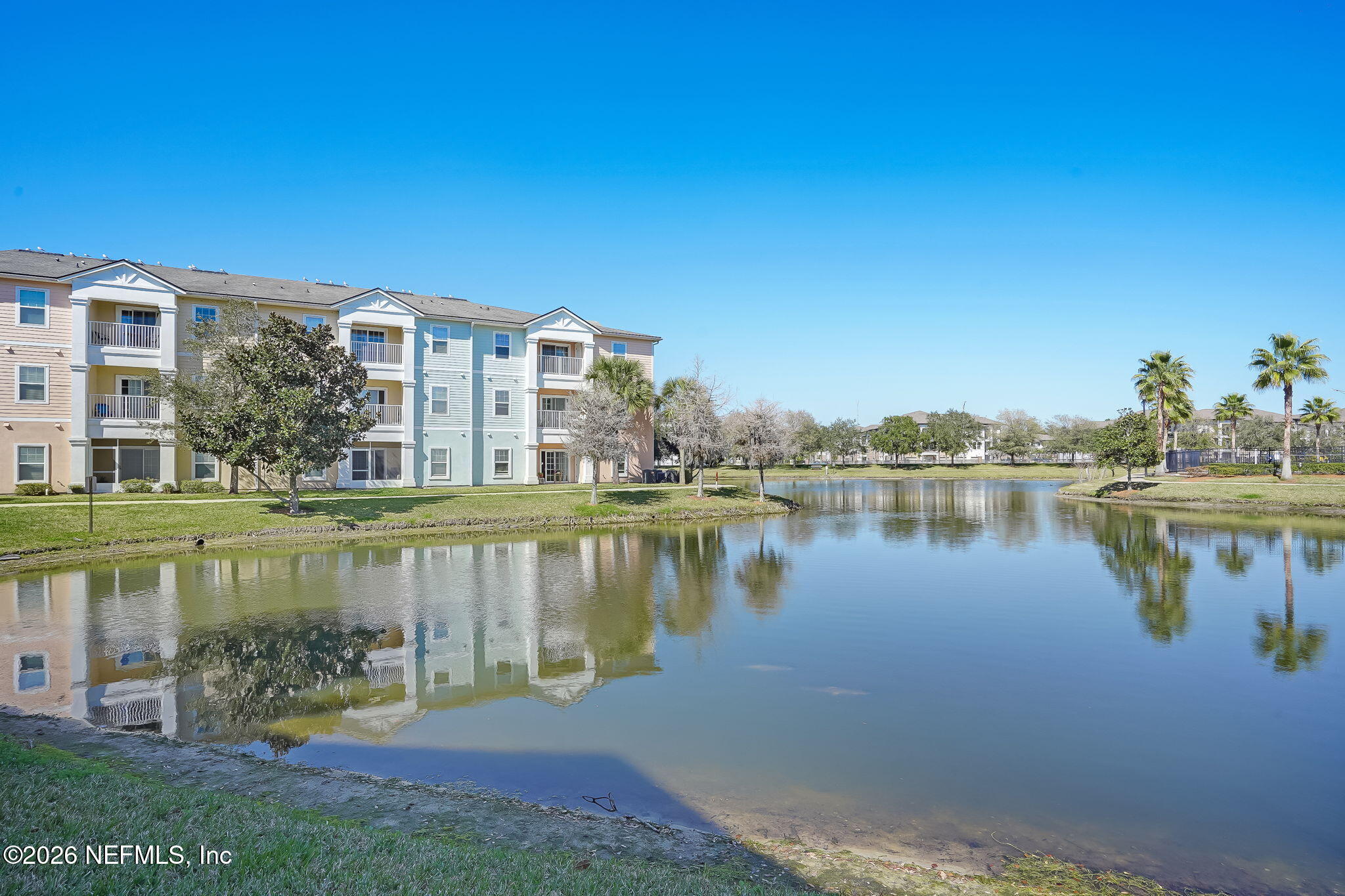 8215 Green Parrot Road, Unit 106 Jacksonville, FL 32256 - Photo 62 of 76 a view of a lake with a building in the background
