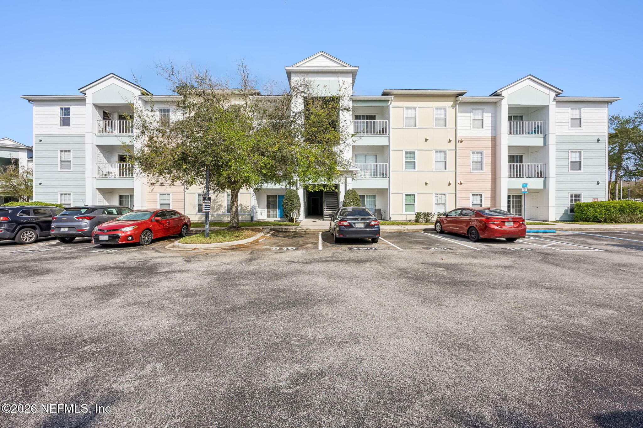 8215 Green Parrot Road, Unit 106 Jacksonville, FL 32256 - Photo 65 of 76 a cars parked in front of a building