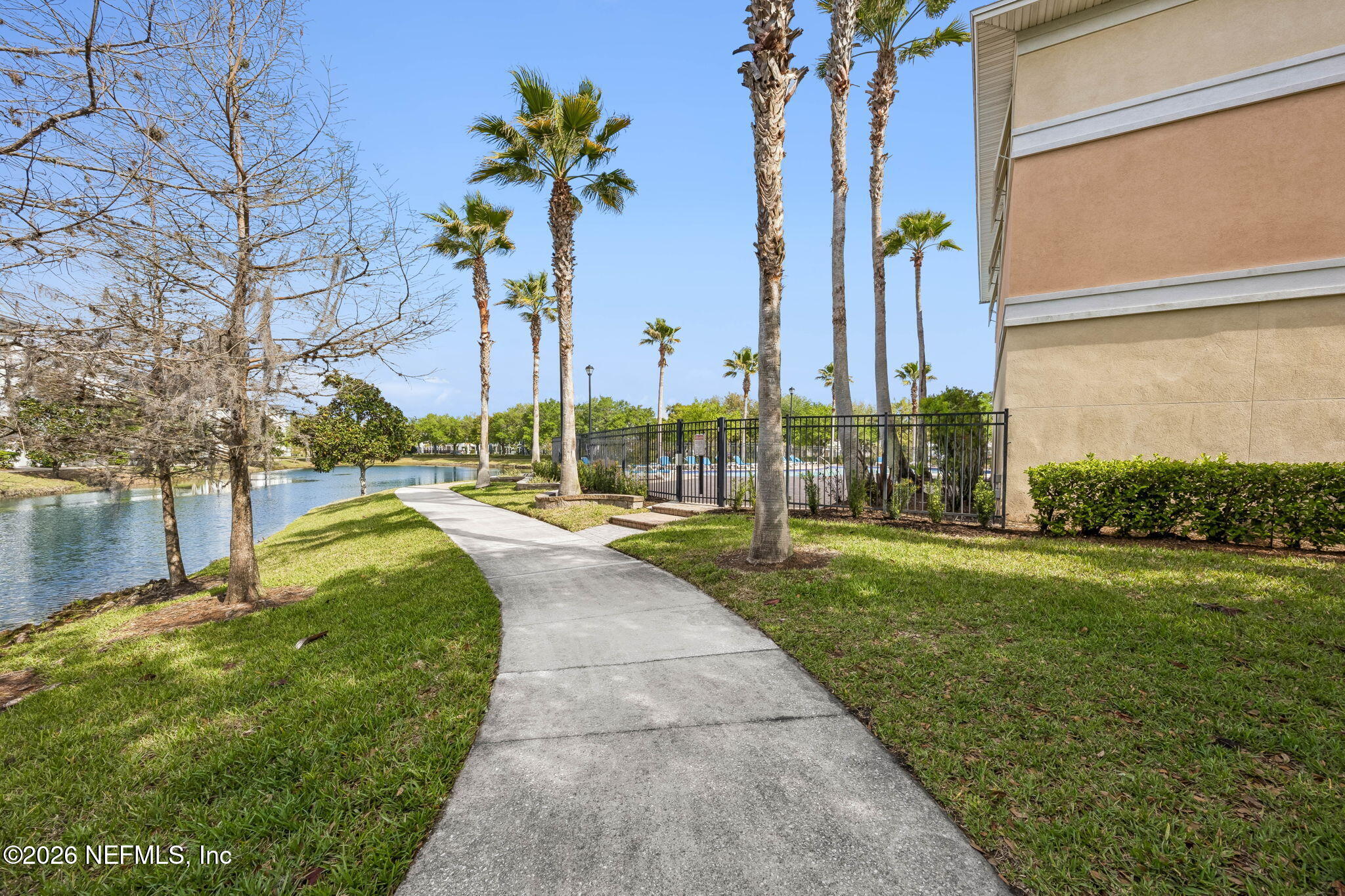 8215 Green Parrot Road, Unit 106 Jacksonville, FL 32256 - Photo 67 of 76 a swimming pool with outdoor seating and yard