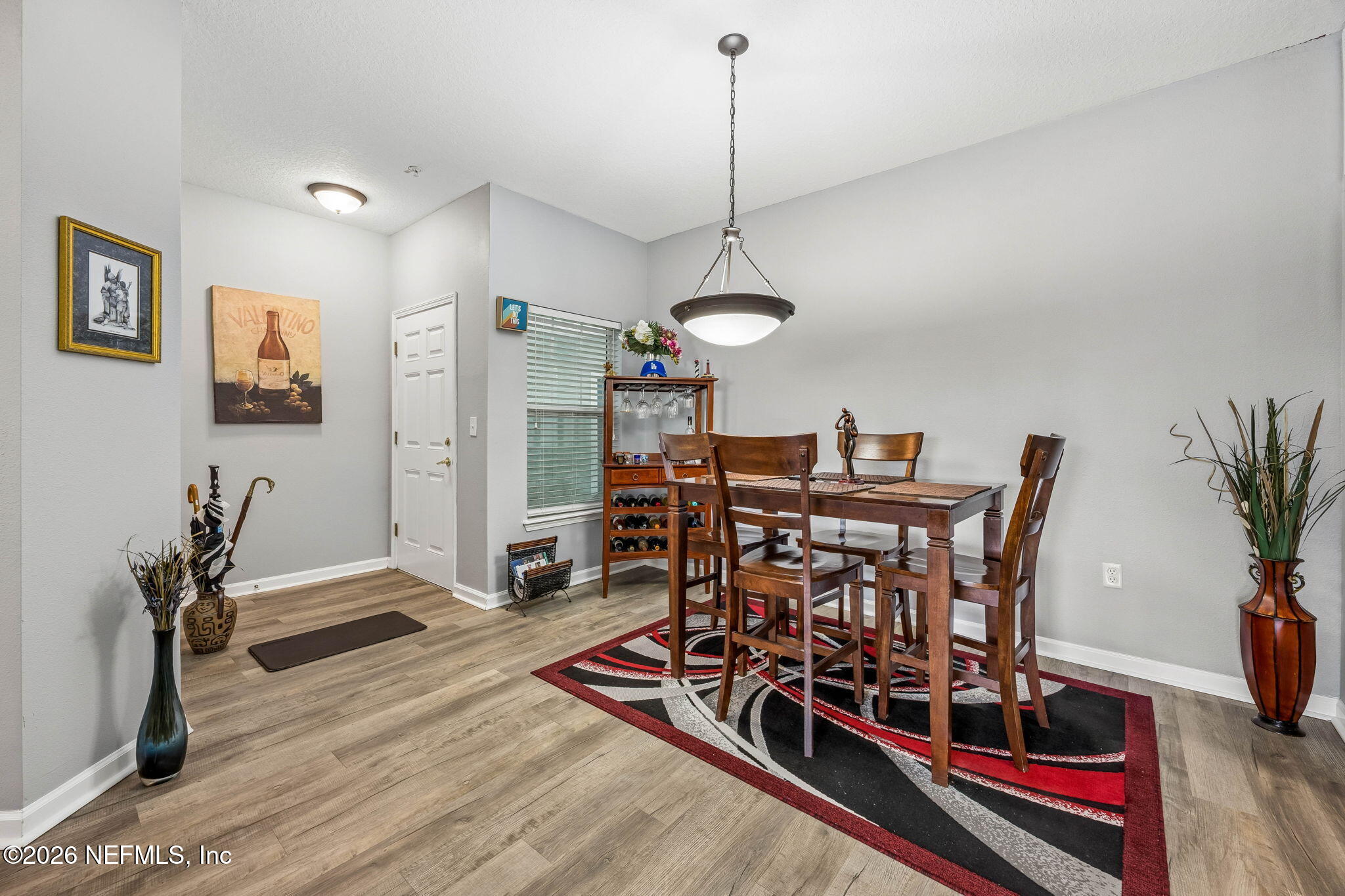 8215 Green Parrot Road, Unit 106 Jacksonville, FL 32256 - Photo 9 of 76 a view of a dining room with furniture and wooden floor