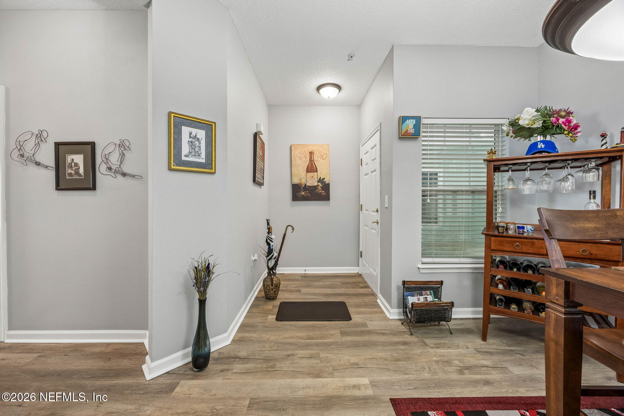 8215 Green Parrot Road, Unit 106 Jacksonville, FL 32256 - Photo 10 of 76 a view of a livingroom with wooden floor and a flat screen tv