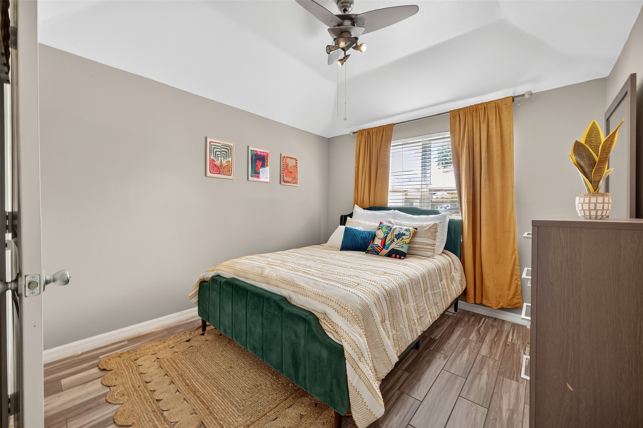 5310 Holly View Drive Houston, TX 77091 - Photo 21 of 38 a bedroom with a bed and wooden floor