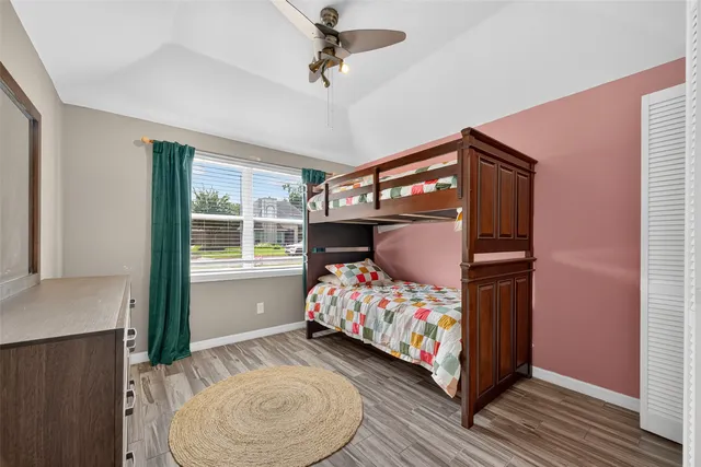 a bedroom with bed and wooden floor