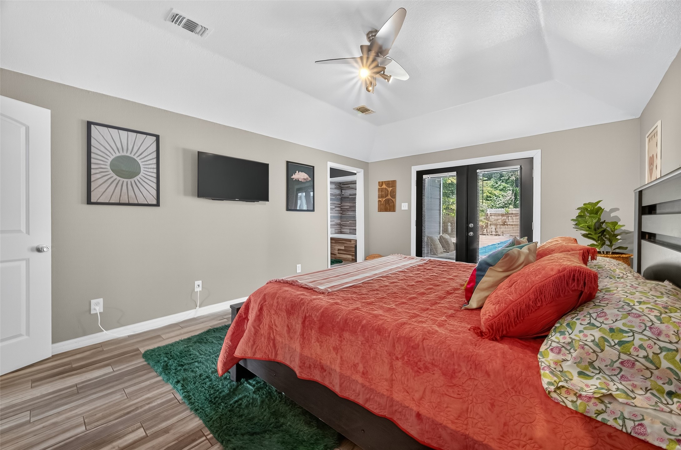 5310 Holly View Drive Houston, TX 77091 - Photo 28 of 38 a bedroom with a large bed and a chandelier