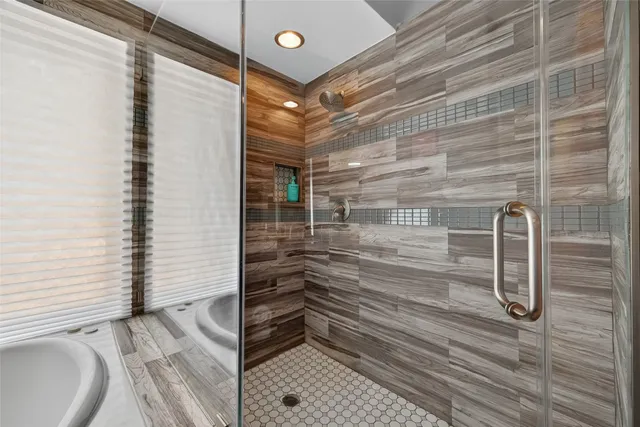 a bathroom with a bathtub and shower