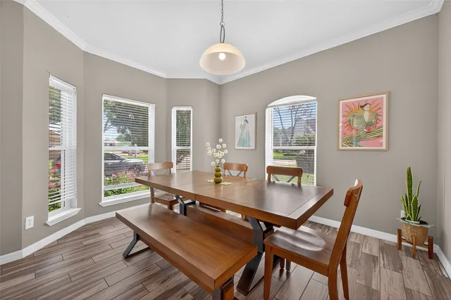 a room with dining table and a large window