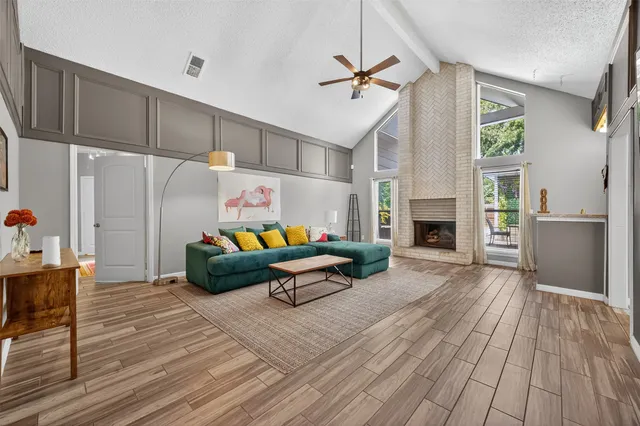 a living room with furniture and a fireplace