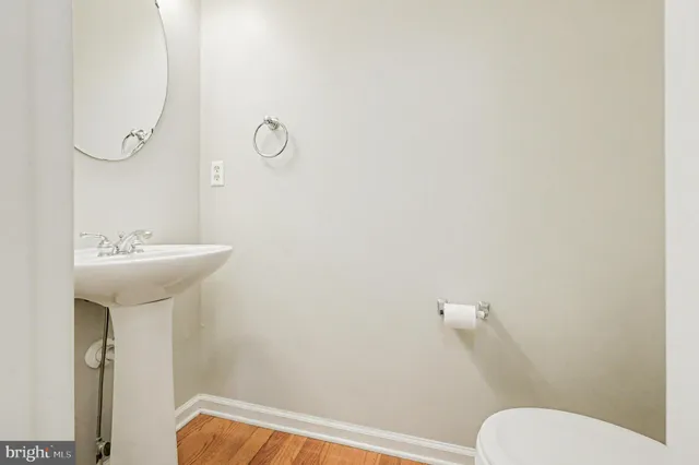 a bathroom with a sink mirror and toilet