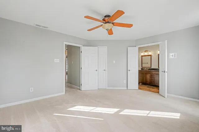 a view of a livingroom with a ceiling fan and wooden floor