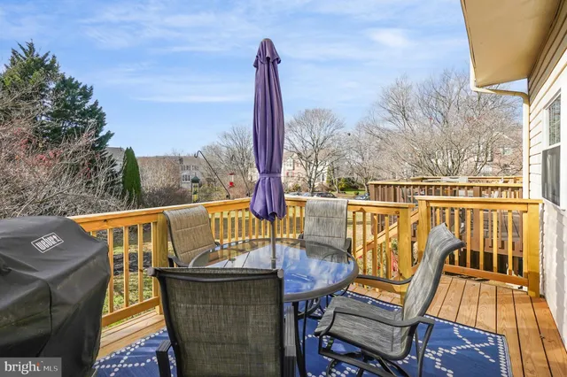 a view of a balcony with wooden floor and outdoor seating