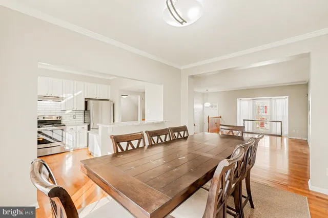 a dining room with furniture and wooden floor