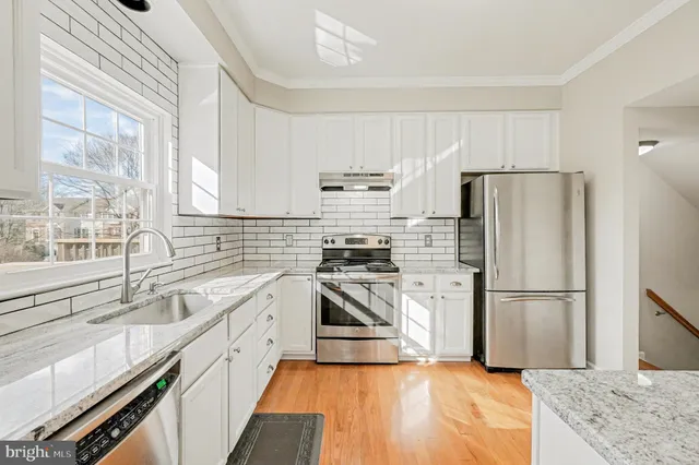 a kitchen with a refrigerator sink and stainless steel appliances
