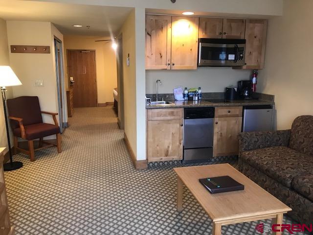 6 Emmons Road, Unit 268 Crested Butte, CO 81225 - Photo 3 of 13 a kitchen with stainless steel appliances granite countertop a stove a sink and a refrigerator