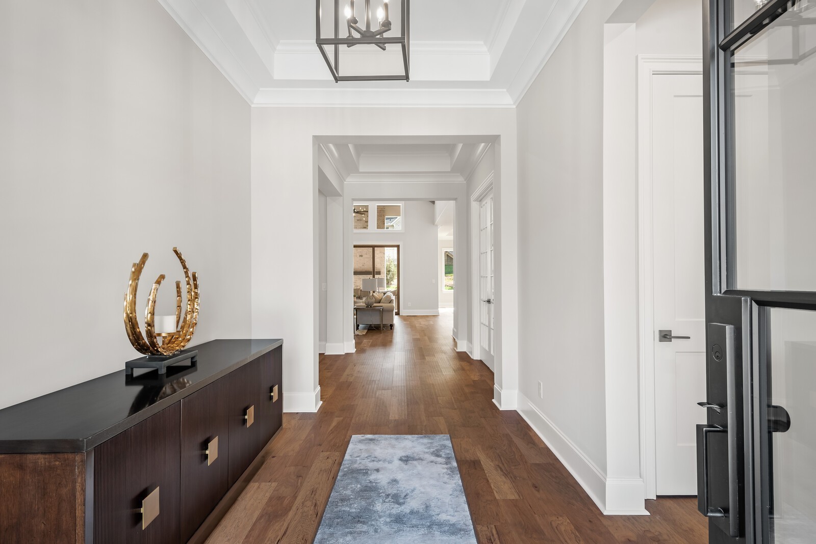 7265 Ruzek Court Fairview, TN 37062 - Photo 7 of 60 a view of a hallway with wooden floor and a fireplace