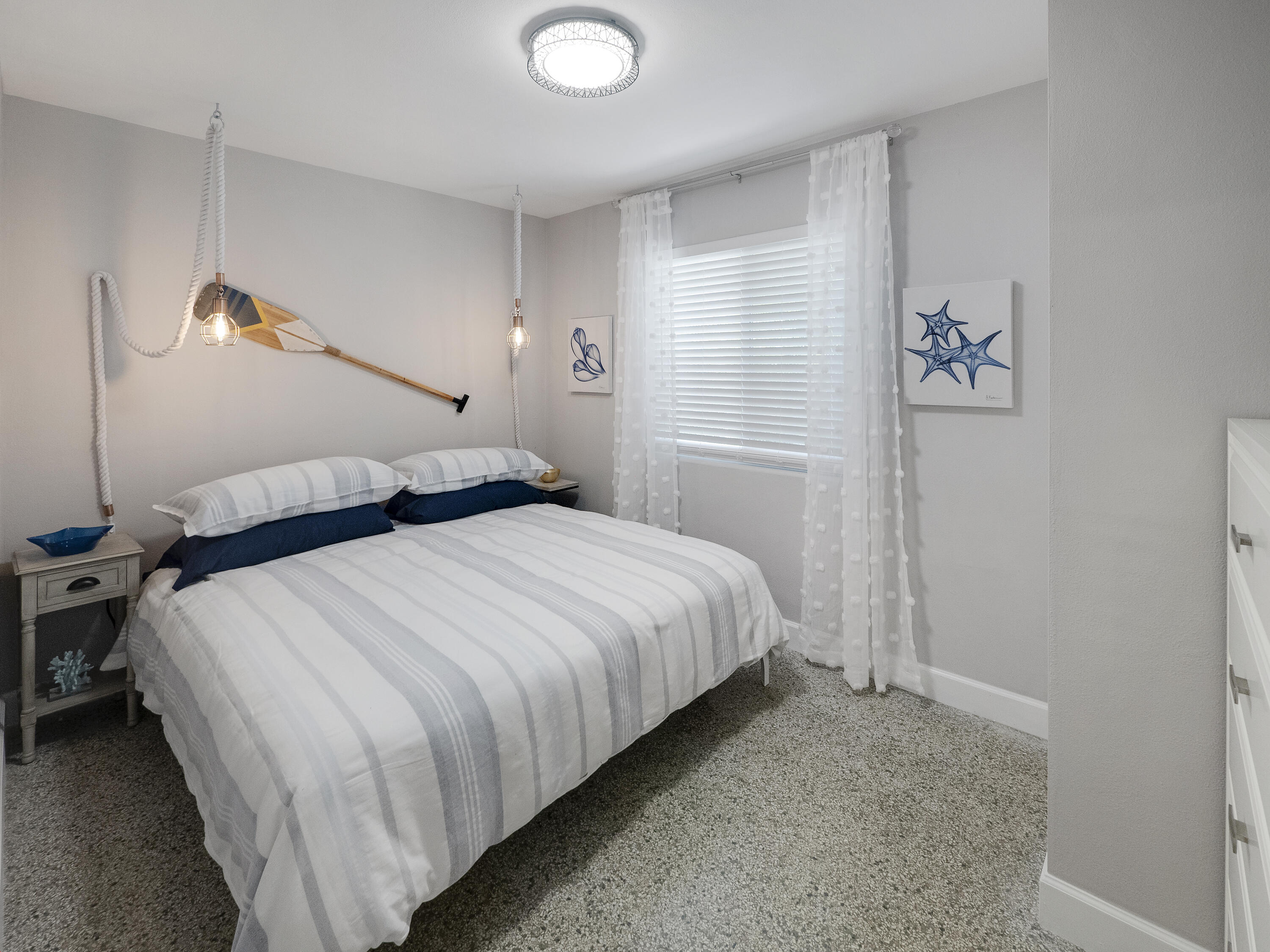 1258 Beach Road, Unit 6 Singer Island, FL 33404 - Photo 10 of 12 a bedroom with a bed and a painting