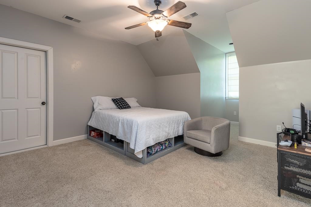 1915 Teague Store Road Somerville, TN 38068 - Photo 33 of 38 Carpeted room featuring a ceiling fan with light fixture, neutral wall paint, and a white paneled door